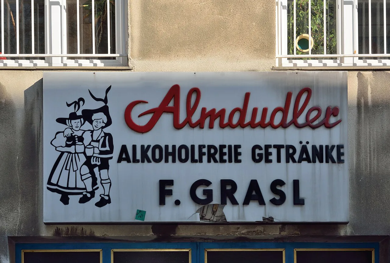 A vintage Almdudler sign above a soft-drinks wholesaler in Vienna's Meidling district.