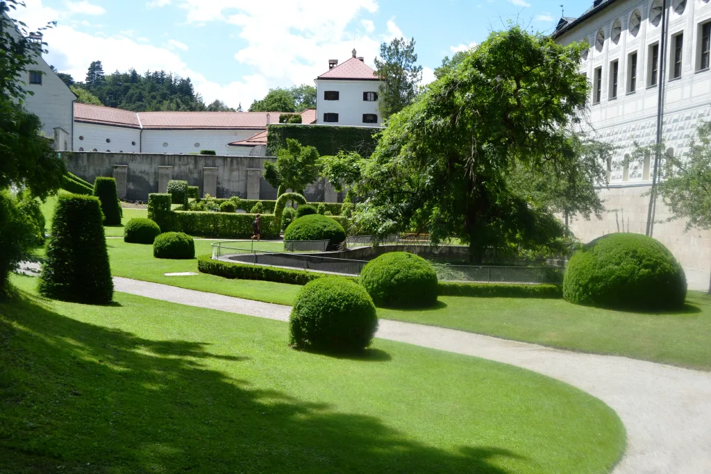 Clipped hedges and lawns in the gardens of Ambras Castle, Innsbruck.