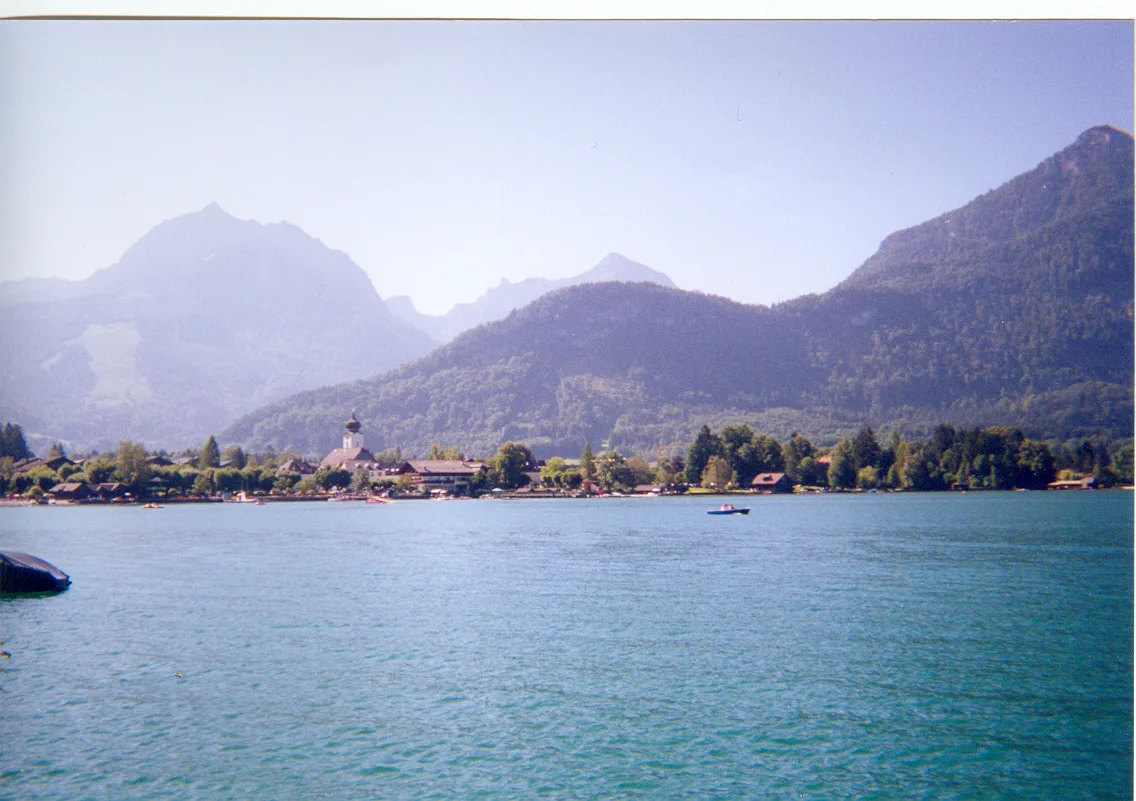 Strobl seen across the Wolfgangsee with mountains behind.