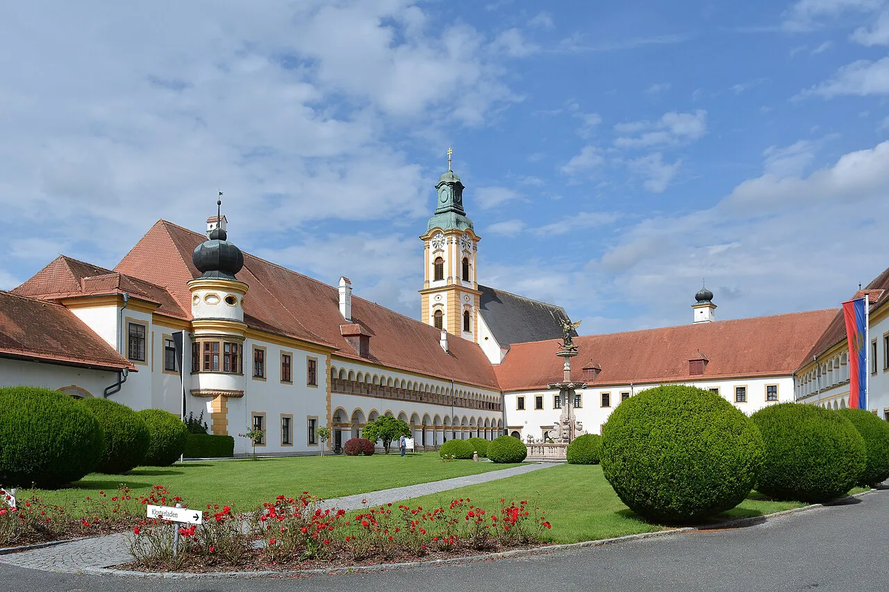 A courtyard of Reichersberg Abbey in Upper Austria, with the abbey church tower.