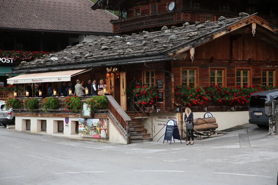 Wooden chalet-style buildings with geranium boxes in the centre of Alpbach, Tyrol.