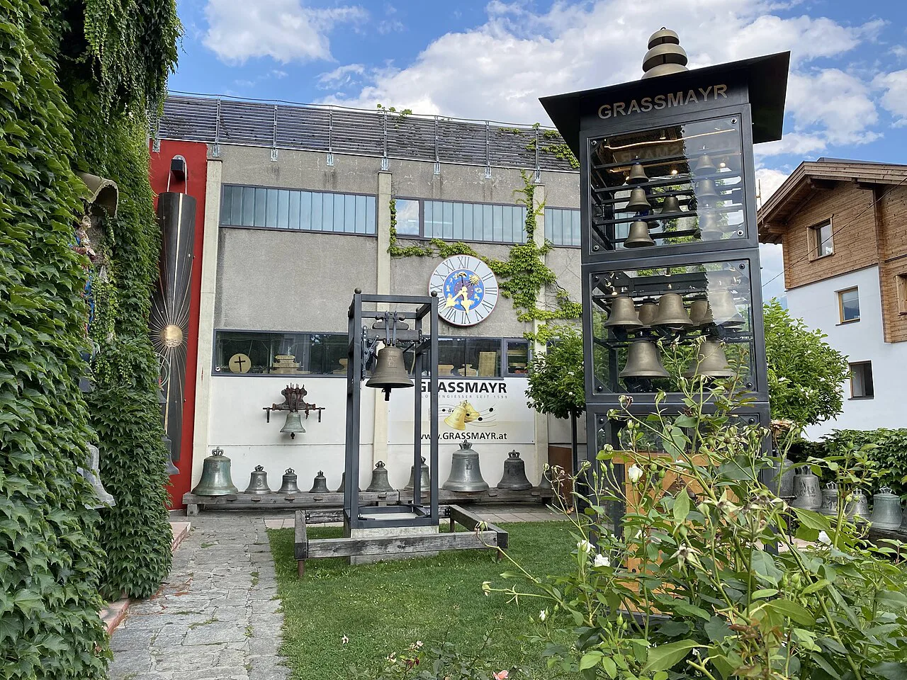 The Grassmayr bell foundry and museum in Innsbruck, with bells displayed in a tower.