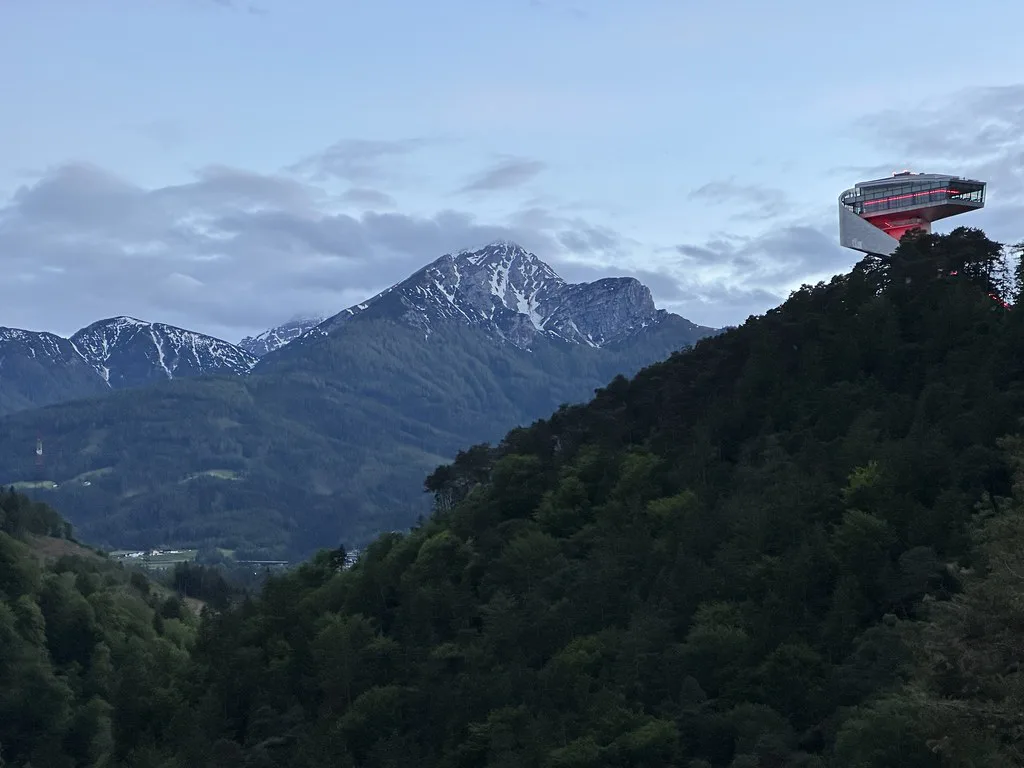 Venue view: the modern Bergisel Ski Jump tower above Innsbruck, with alpine mountains beyond.
