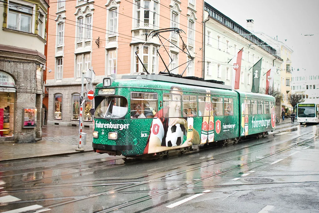 A tram on a rainy street in central Innsbruck.