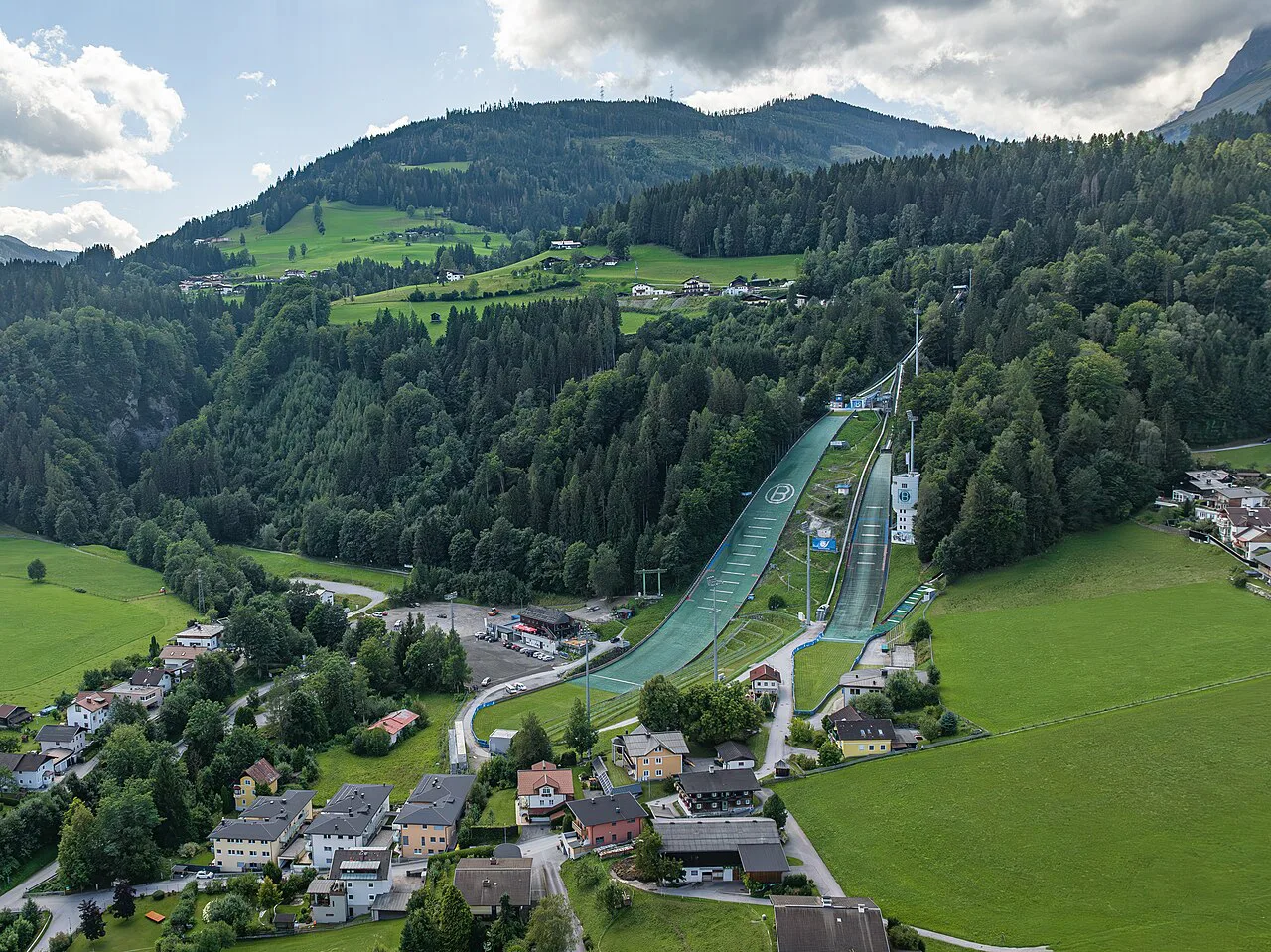 The Bischofshofen ski jumps set into the wooded valley slope.