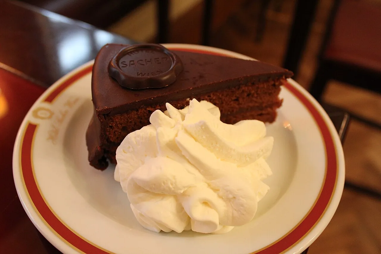 A slice of Sachertorte with whipped cream at Café Sacher in Innsbruck.