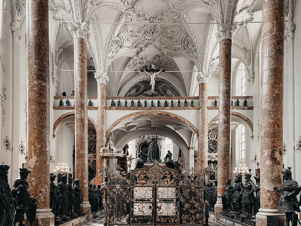 Emperor Maximilian's cenotaph surrounded by bronze statues in Innsbruck's Hofkirche.