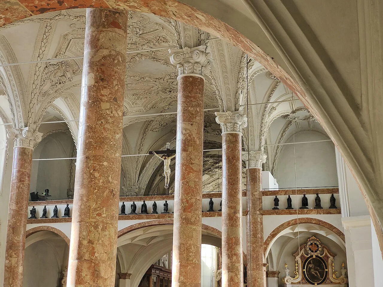 Red marble columns and galleries inside the Hofkirche in Innsbruck.