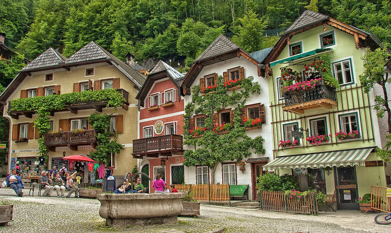 Flower-decked houses and fountain on Hallstatt's market square.