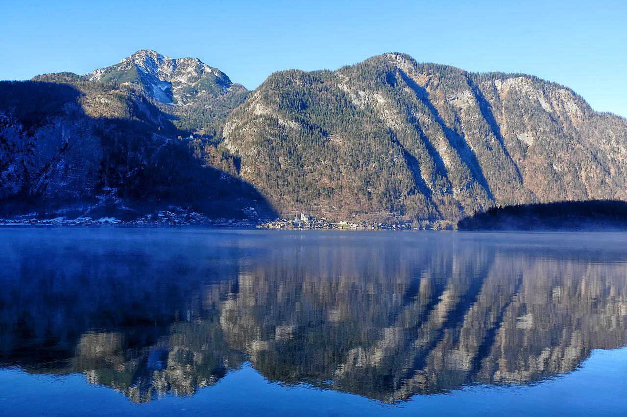 Mountains reflected in Lake Hallstatt in the Dachstein Salzkammergut region.