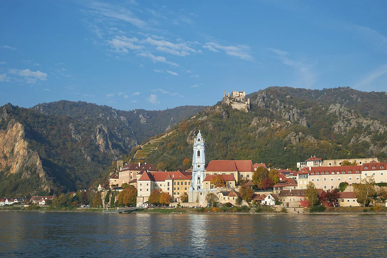 Dürnstein in autumn, with the abbey's blue tower, the castle and the castle ruin above.