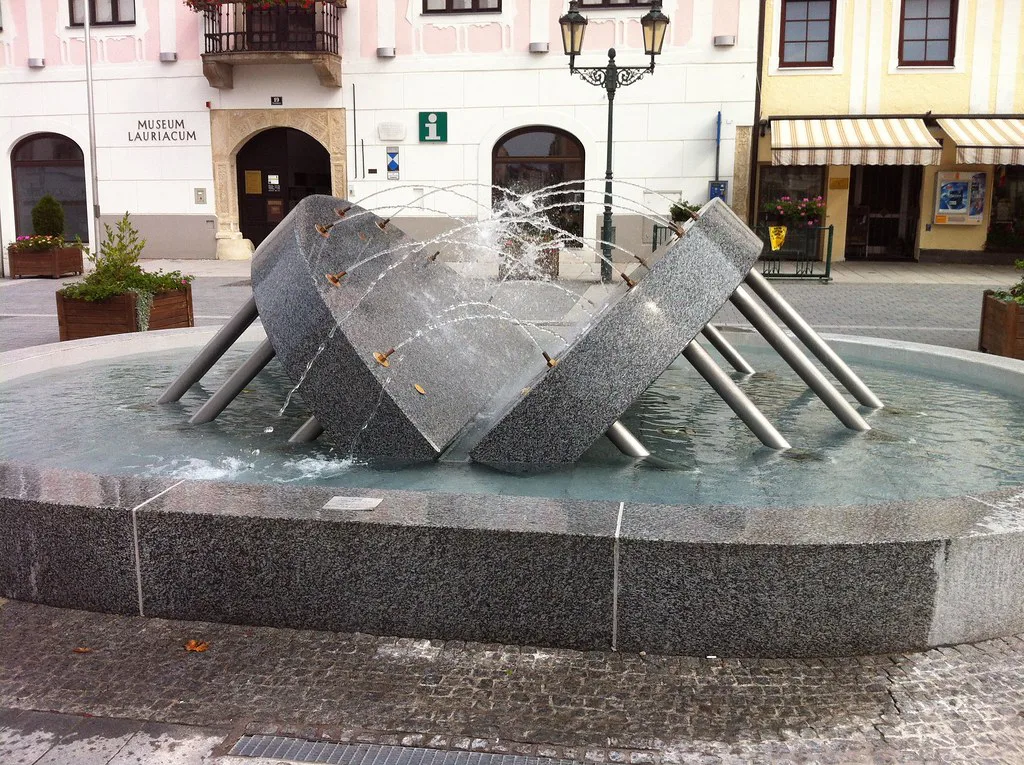A modern stone fountain on the main square of Enns.