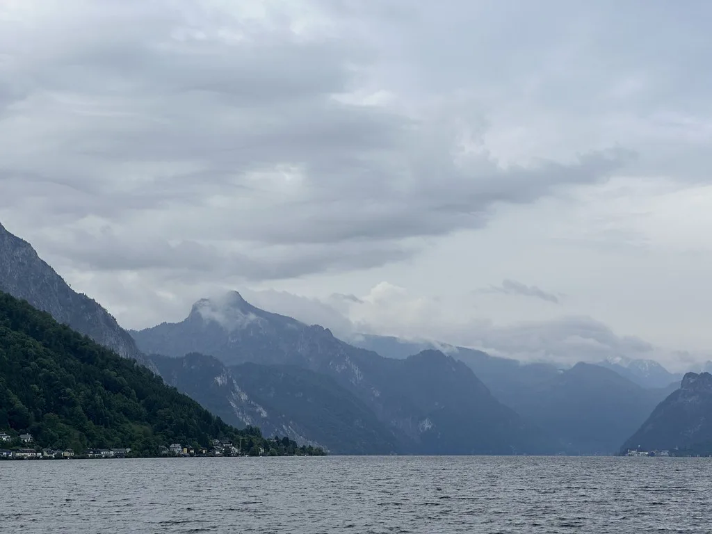 The Traunsee and its surrounding mountains seen from Gmunden on a cloudy day.