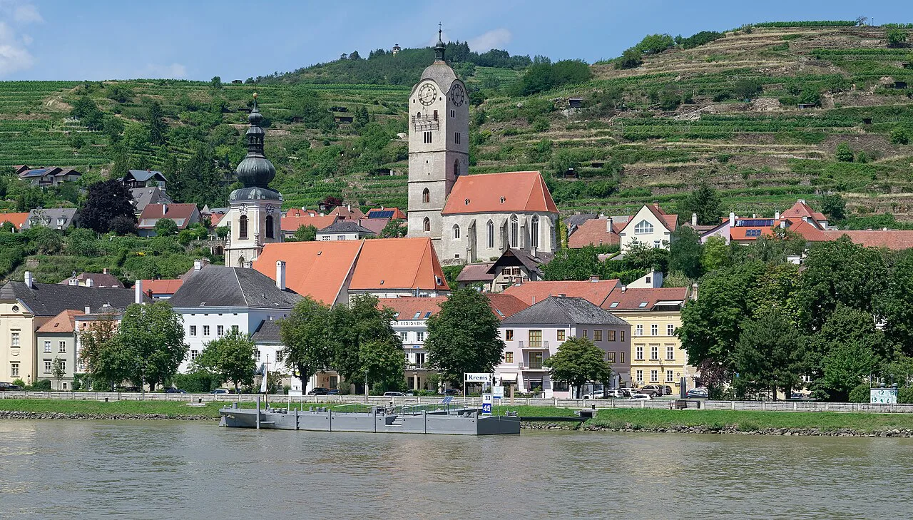 The Stein district of Krems an der Donau seen from the Danube, with vineyards above.