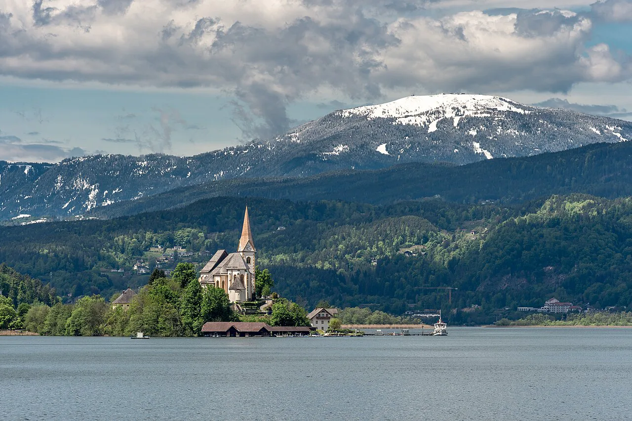 Maria Wörth church on the Wörthersee with the snow-capped Gerlitzen behind.