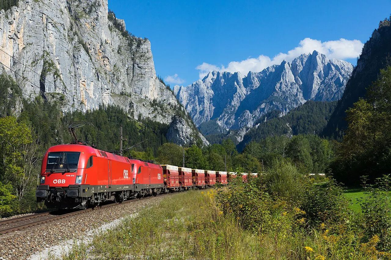 A red freight train beneath the Gesäuse cliffs near the former Gesäuse Eingang station.