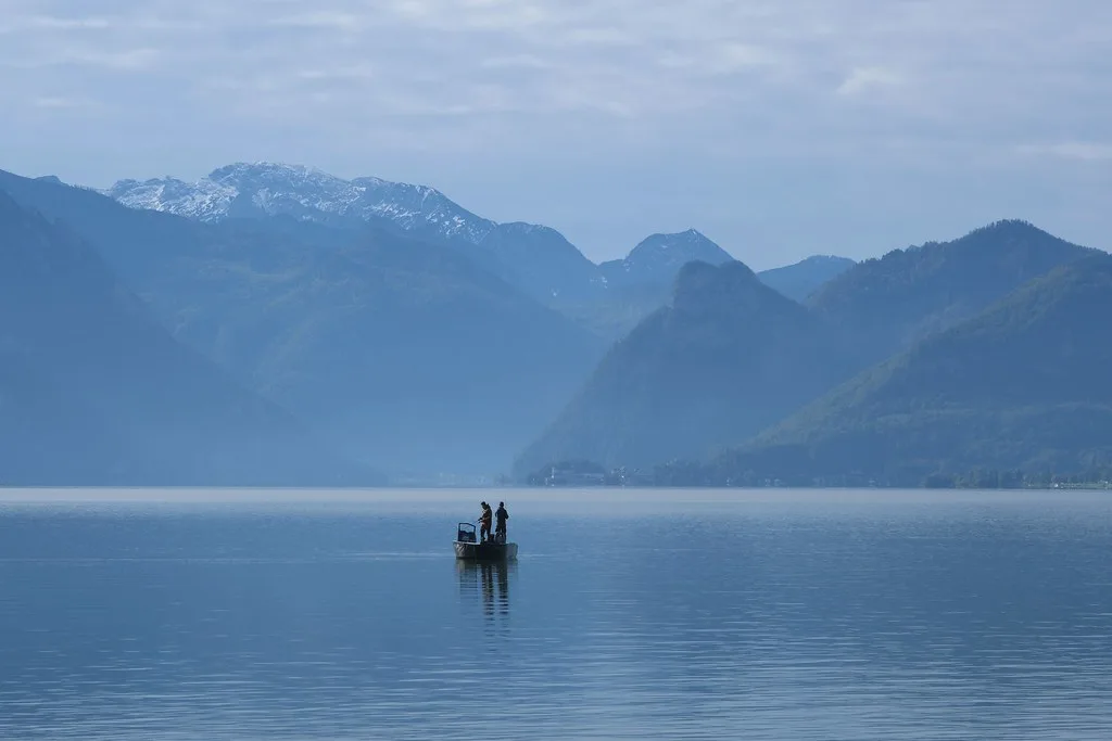 A small boat on Lake Traunsee near Gmunden, with mountains beyond.