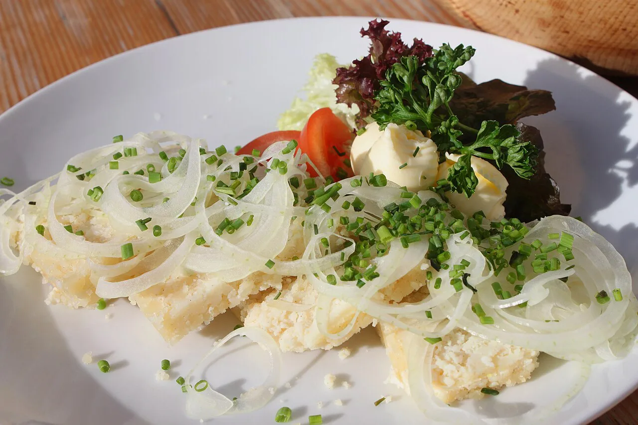 Graukäse dressed with onions and chives, served at the Huberalm in Antholz, South Tyrol.