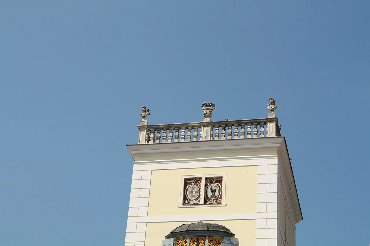 The carillon tower of Heiligenkreuz Abbey against a blue sky.