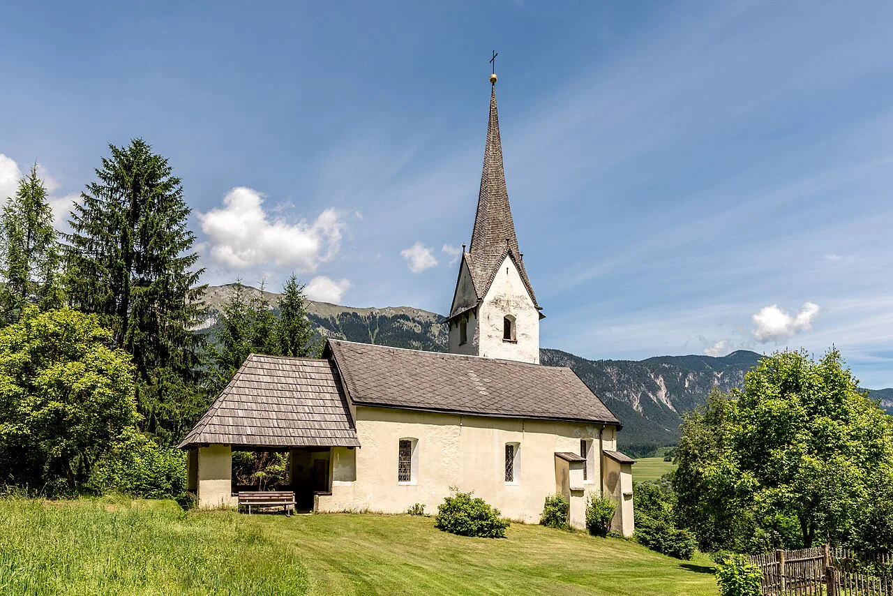 St Leonard's Church in Latschach, Hermagor, among meadows and trees.