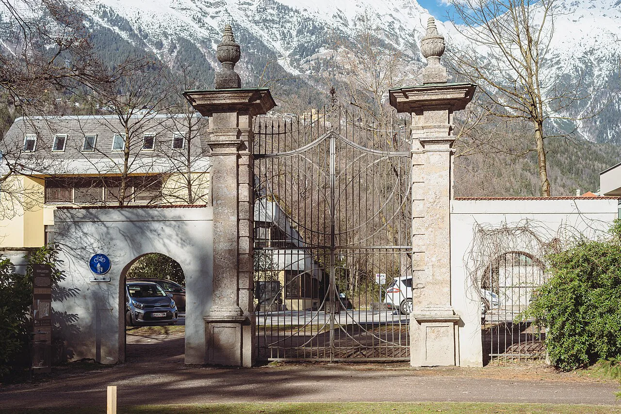 The Hofgarten gate in Innsbruck, with snowy mountains behind.