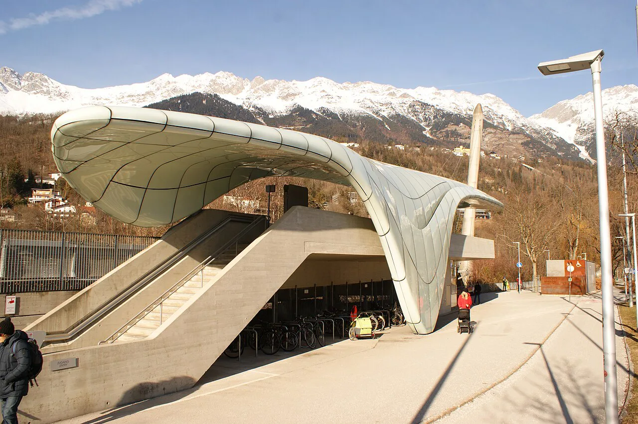 The Löwenhaus station of the Hungerburgbahn in Innsbruck, with snowy mountains behind.