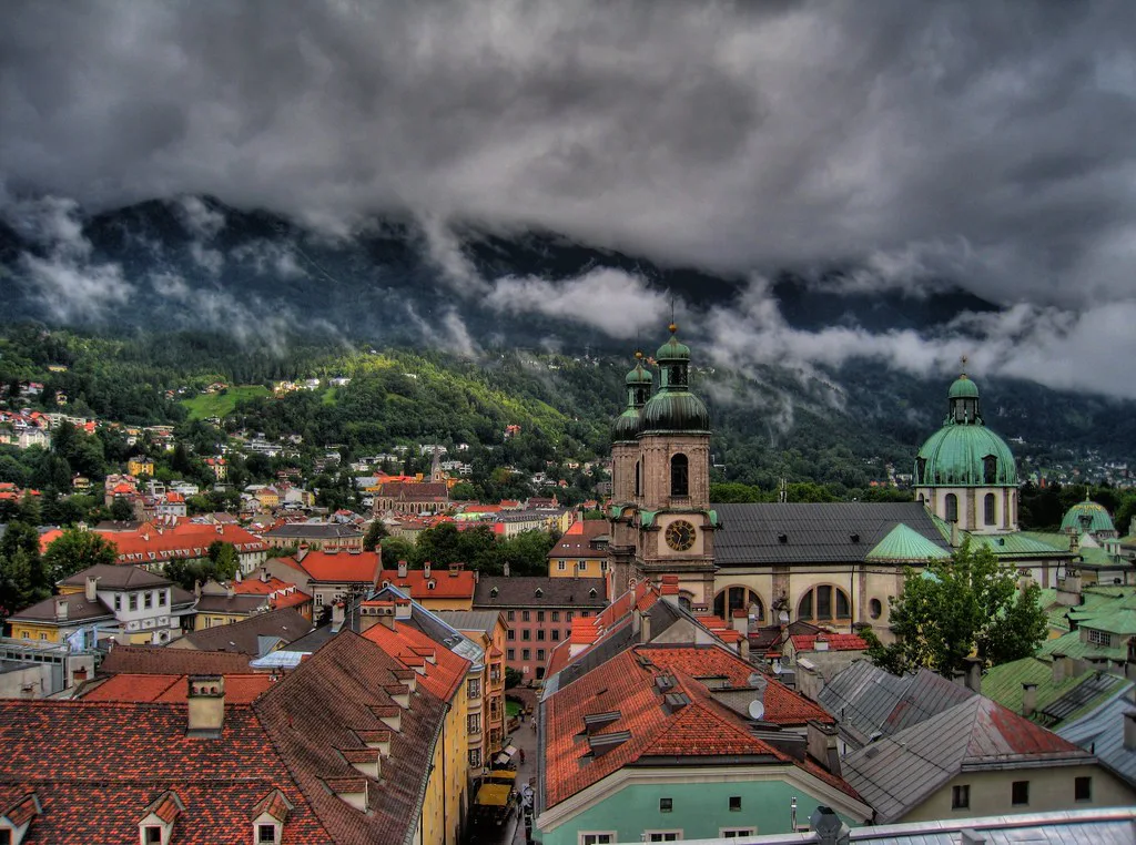 Innsbruck's old-town rooftops, the cathedral and mountains seen from the City Tower.