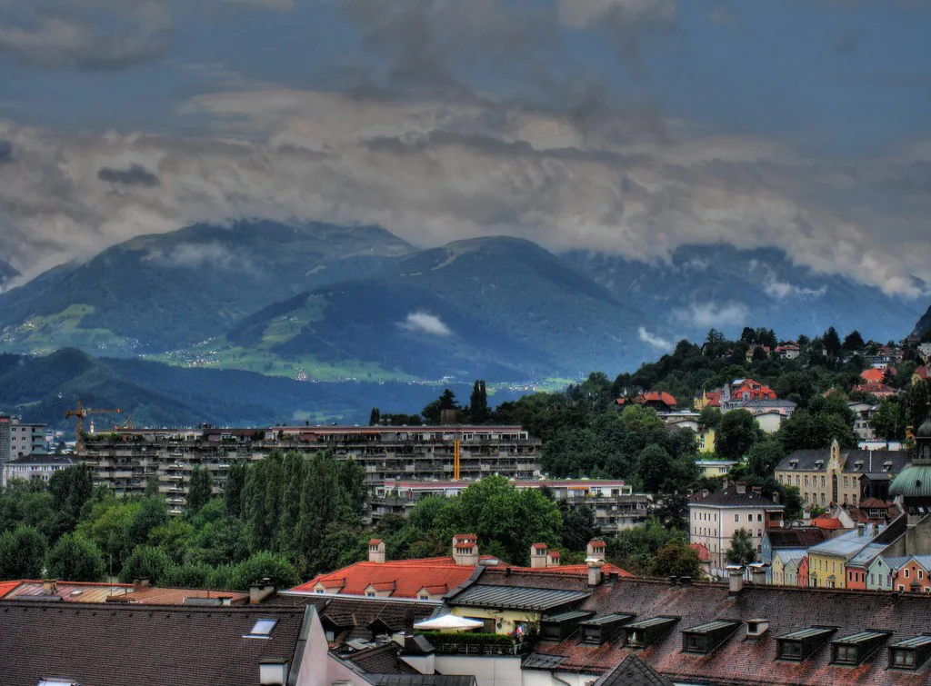Innsbruck rooftops and cloud-wrapped mountains seen from the City Tower.