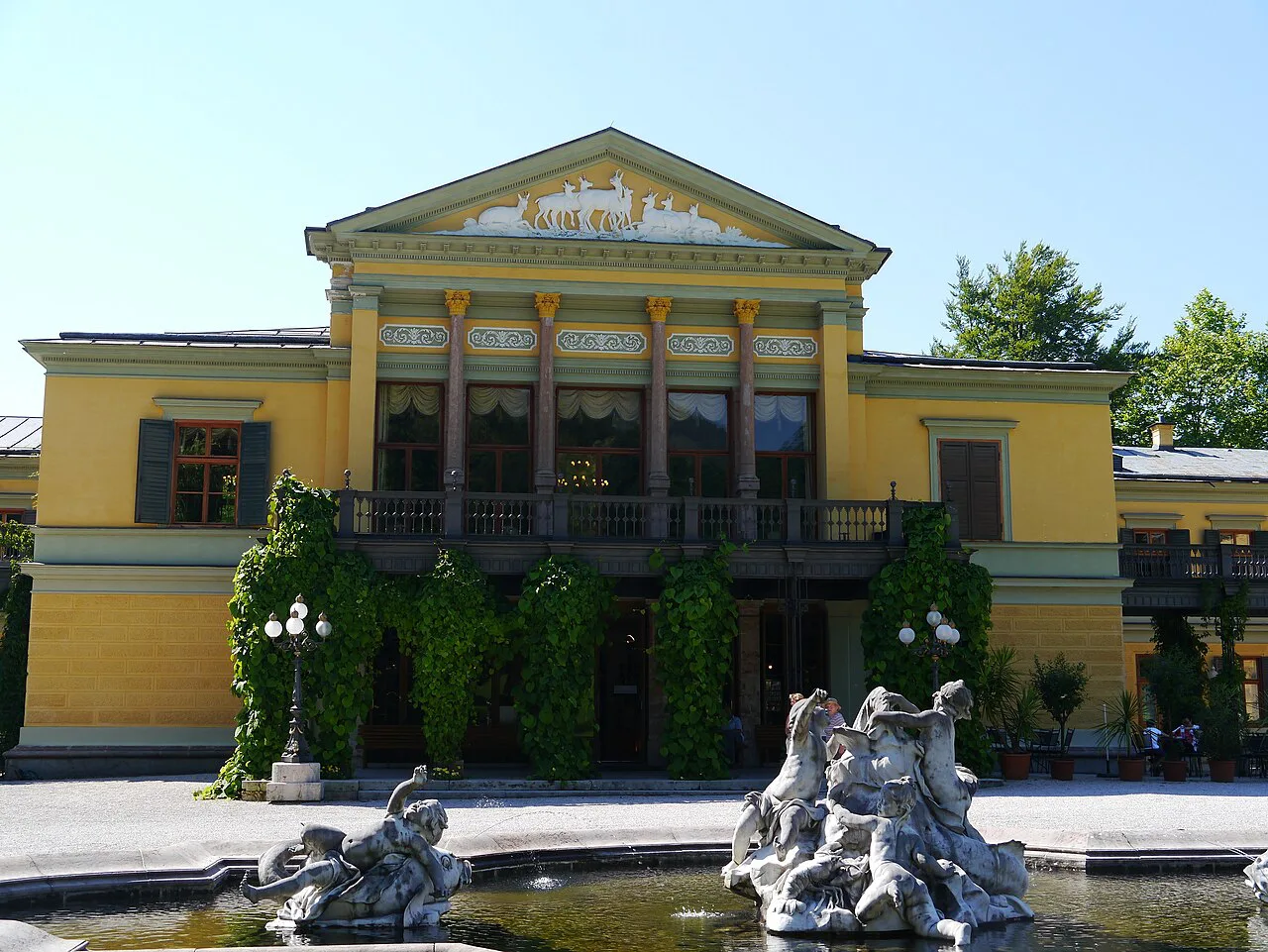 The yellow facade and fountain of the Kaiservilla in Bad Ischl.
