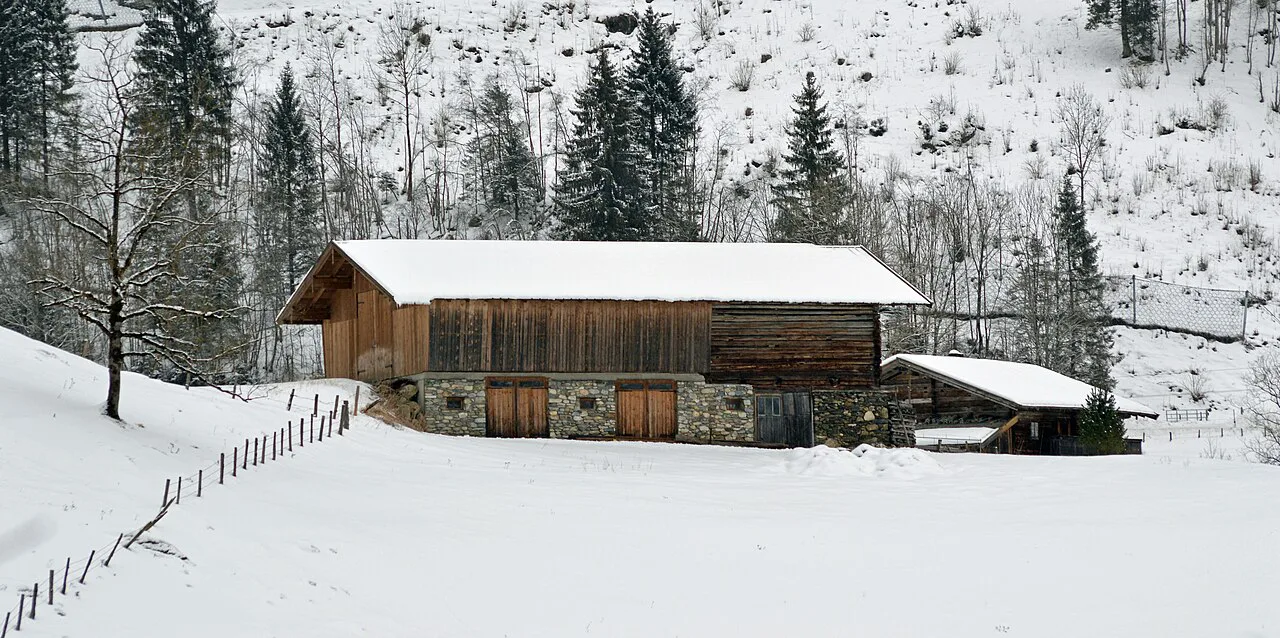 The historic Tauernhaus Bürg in Kaprun under winter snow.