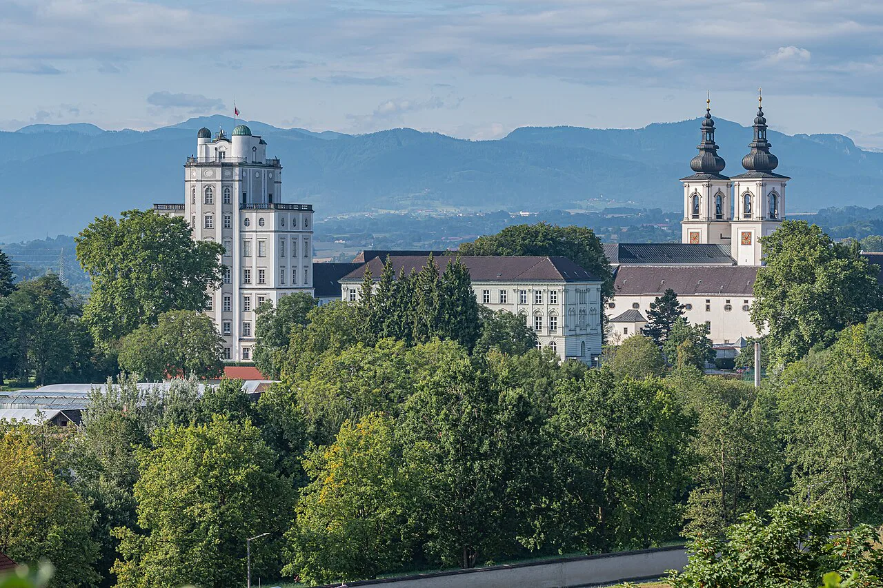 Kremsmünster Abbey with its observatory tower and twin church towers above the trees.