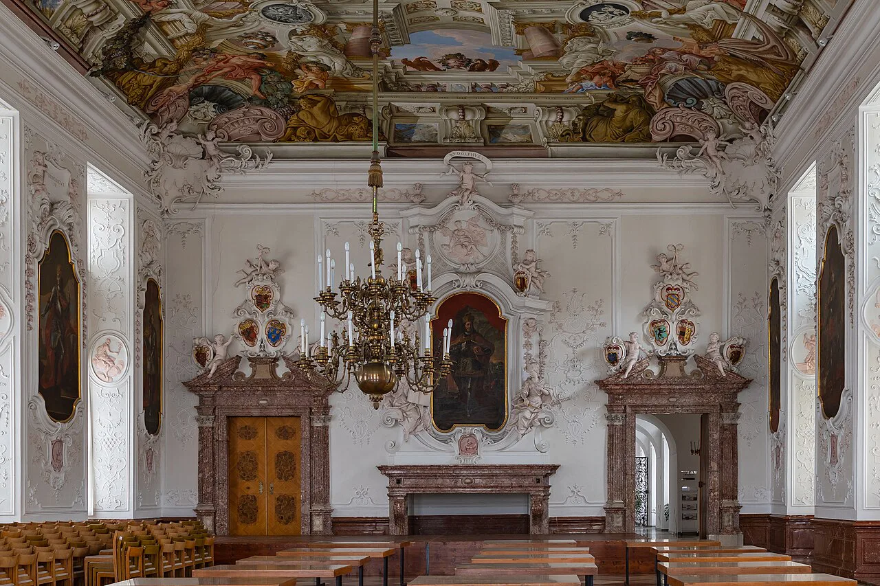 The Emperor's Hall inside Kremsmünster Abbey, with ceiling frescoes and a chandelier.