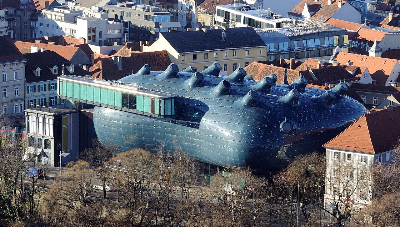 The Kunsthaus Graz among the old-town roofs, seen from above.