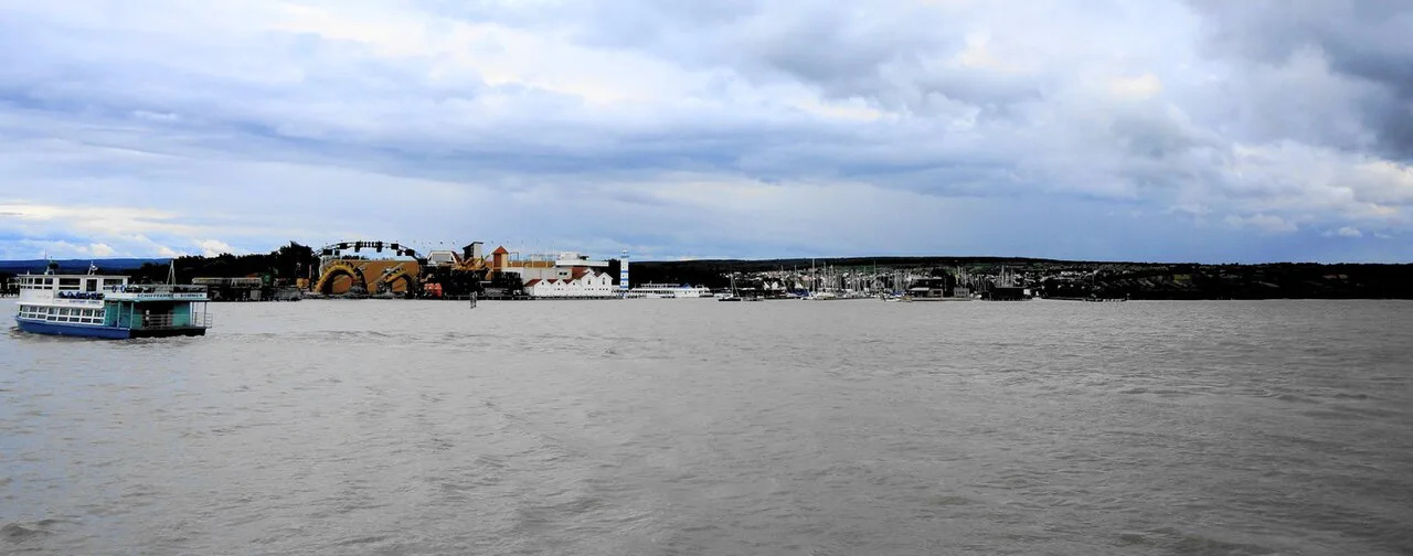 Lake Neusiedl at Mörbisch, with a passenger boat and the lakeside stage on the shore.