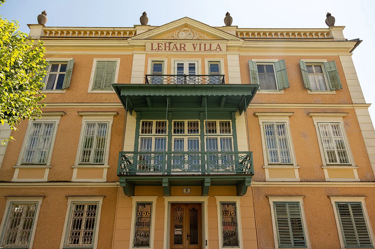 The yellow facade and green balconies of the Lehár Villa in Bad Ischl.