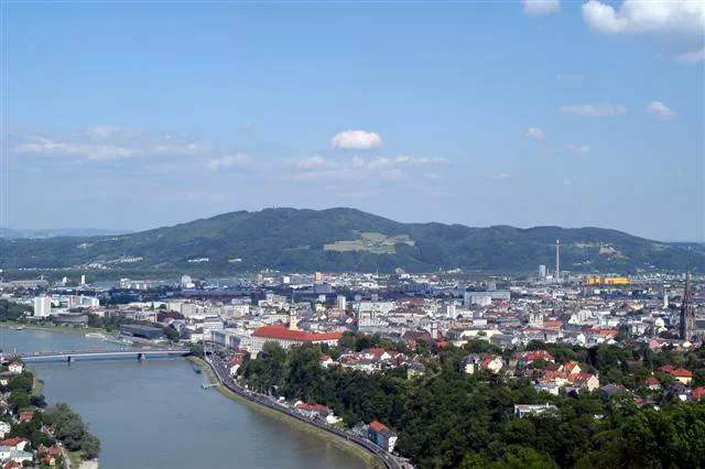Linz spread along the Danube, seen from the hills above the city.