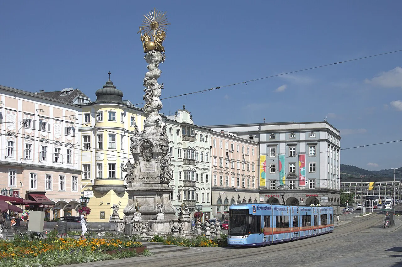 A tram passing the Trinity Column on Linz's Hauptplatz.