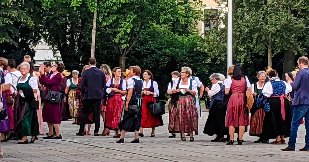 Women in traditional dirndl costume gathered near the Mariendom in Linz.