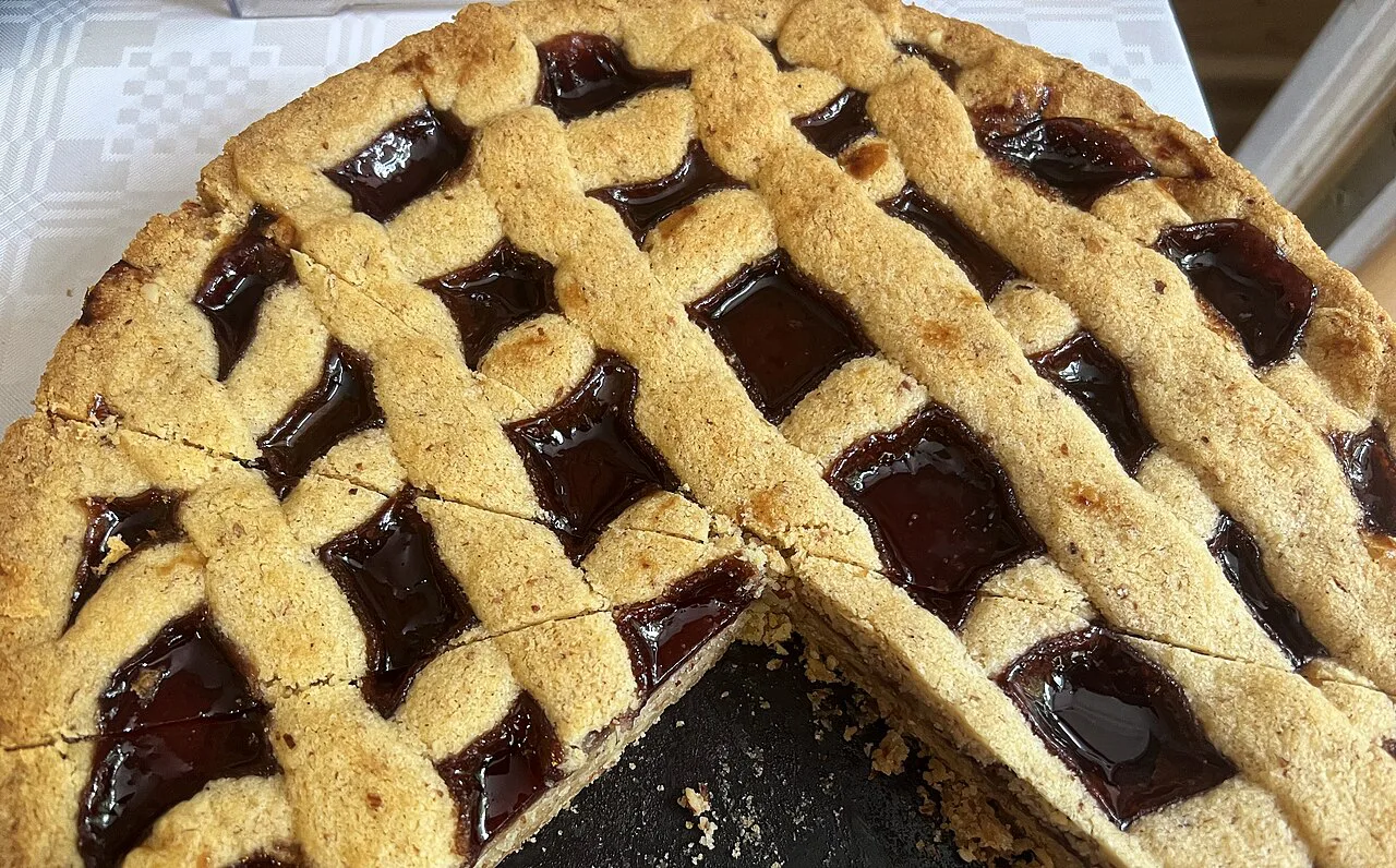 A whole Linzer Torte with its lattice top and jam filling.