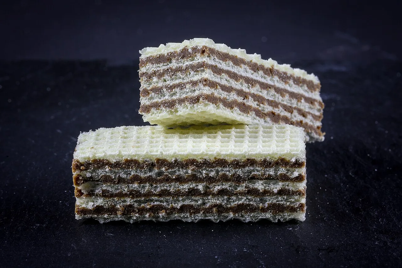 Manner Neapolitaner hazelnut cream wafers stacked against a dark background.