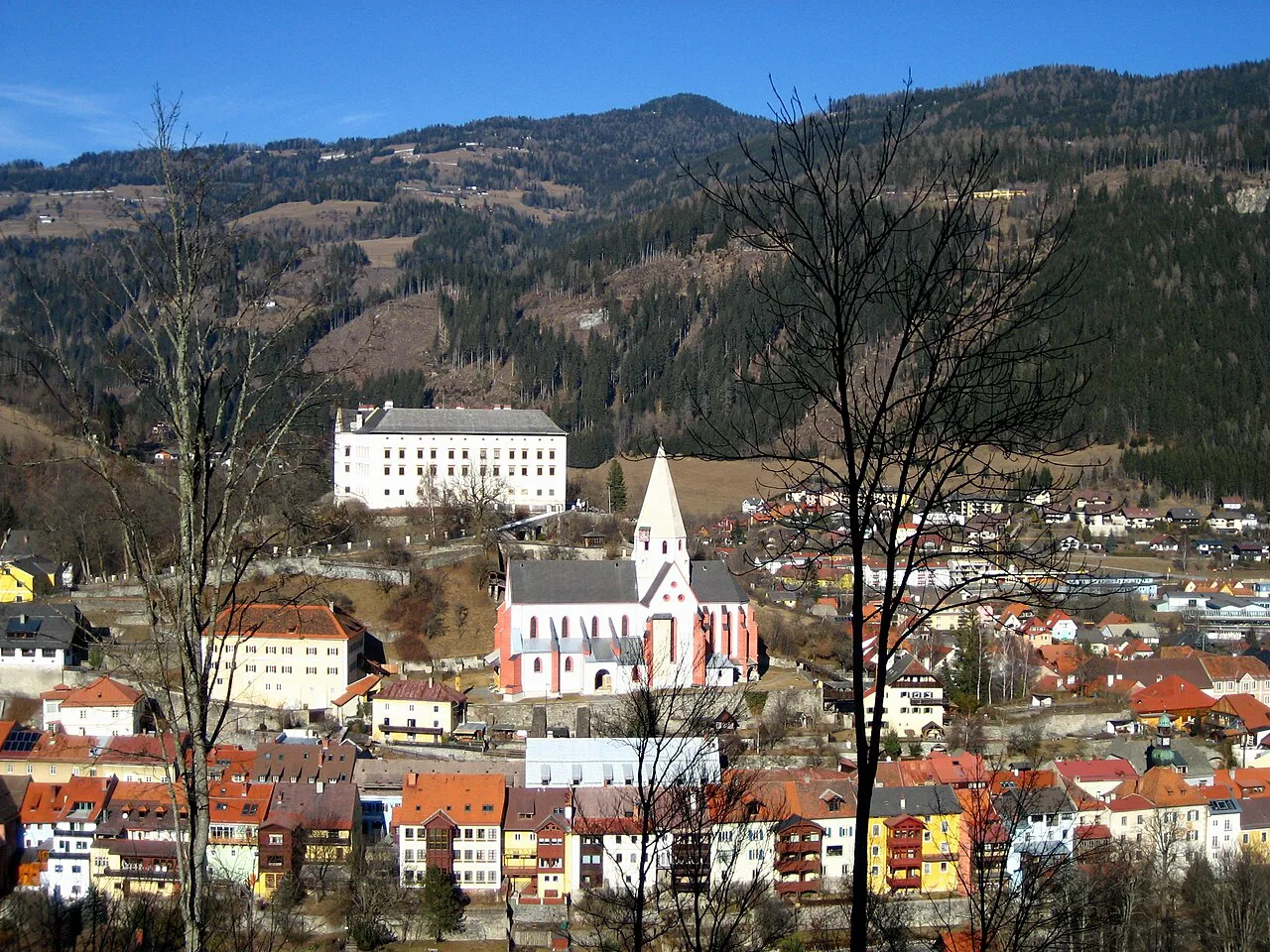 Murau's rooftops and church below the wooded hills of Styria.