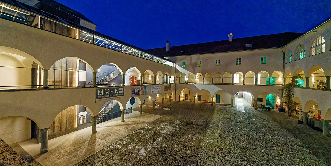 The arcaded courtyard of the Burg in Klagenfurt, home to the Museum of Modern Art Carinthia, at dusk.
