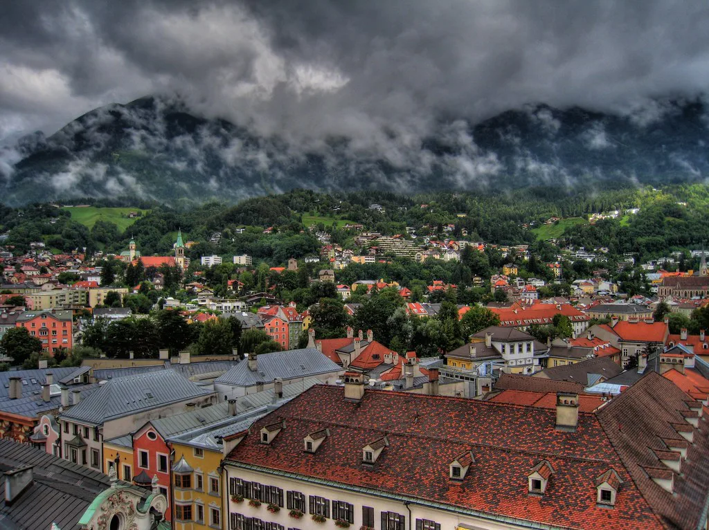Innsbruck's old-town rooftops and surrounding mountains seen from the City Tower.