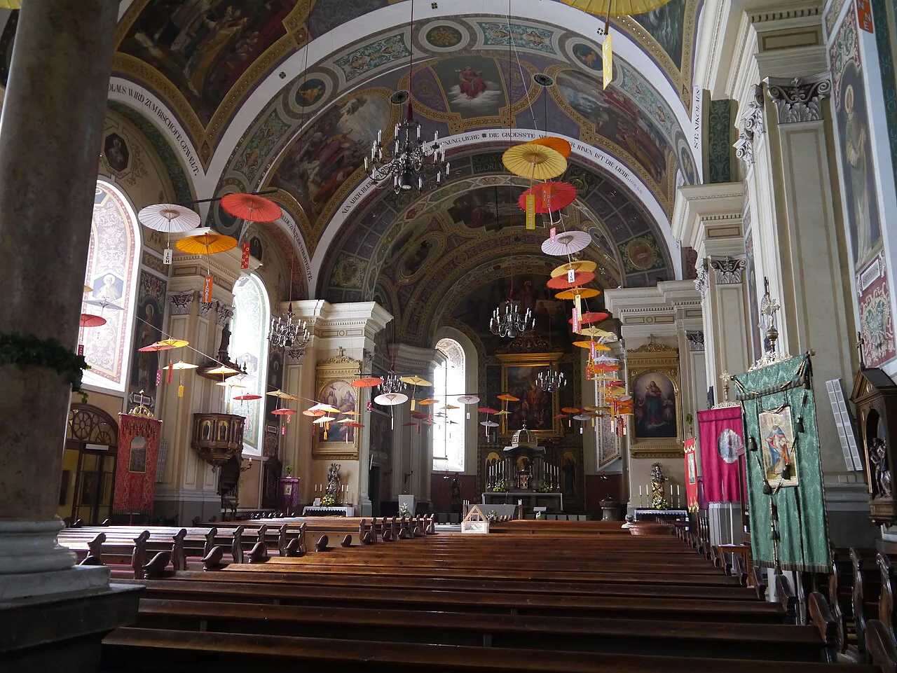 The nave of St. Nicholas parish church in Bad Ischl, looking towards the altar.