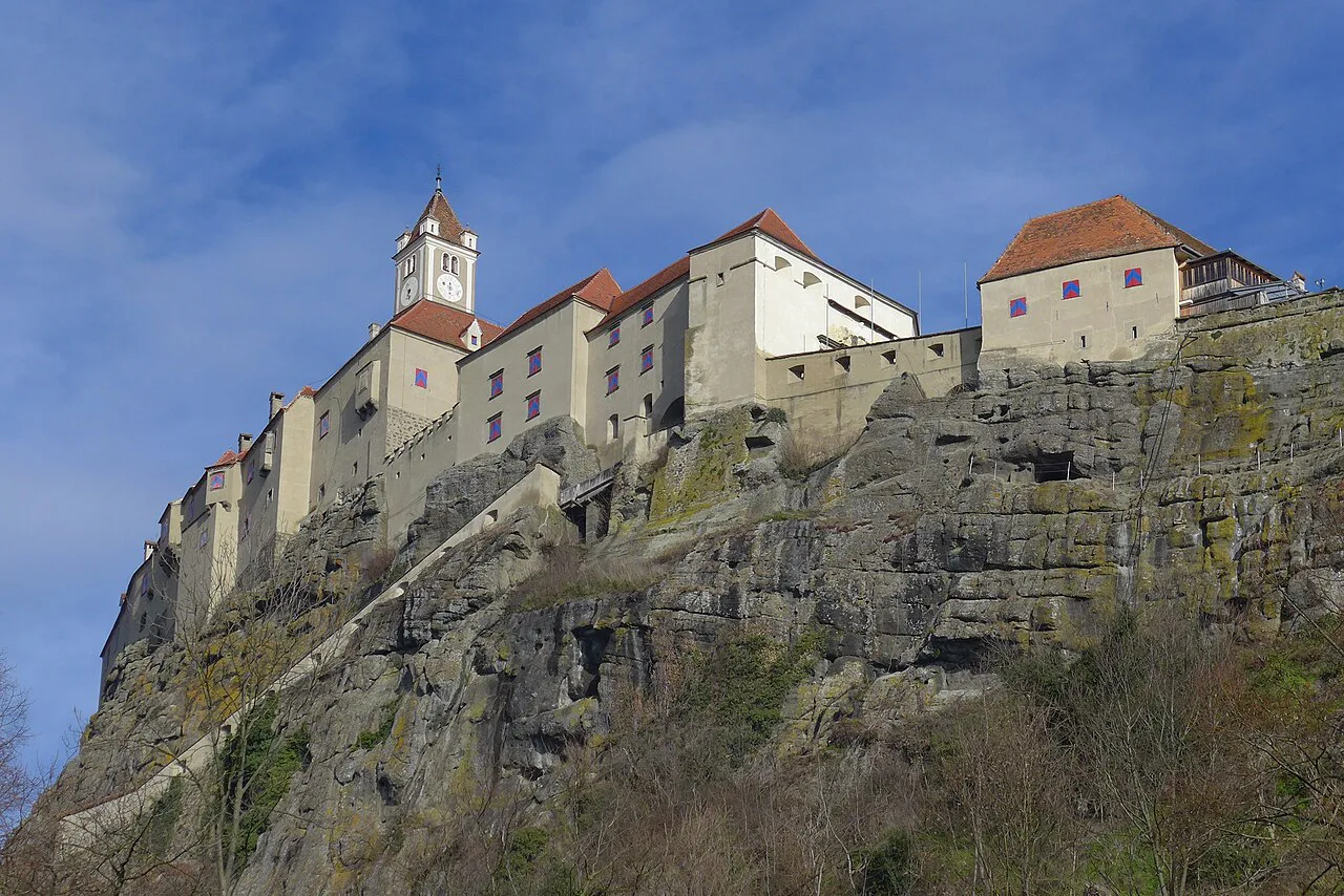 The walls and buildings of Riegersburg Castle above the sheer rock face.