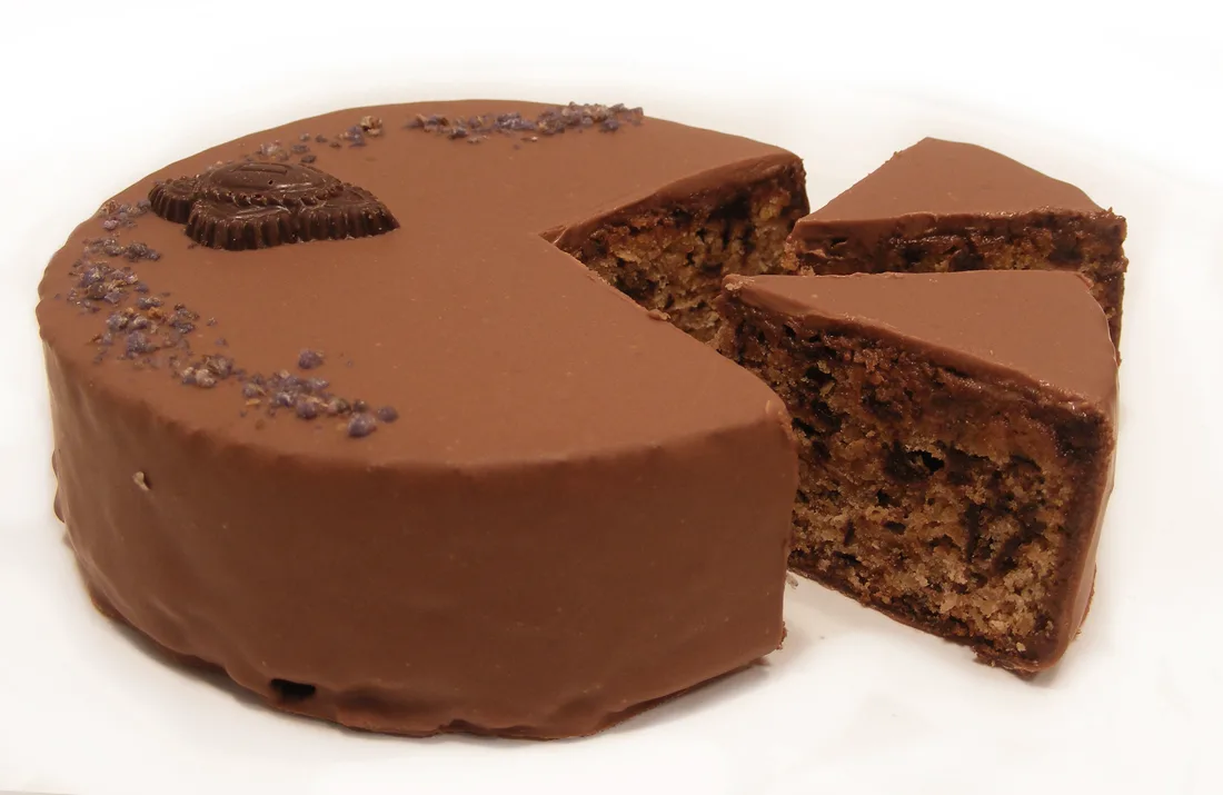 A chocolate-glazed Sachertorte from the Demel bakery, with slices cut.