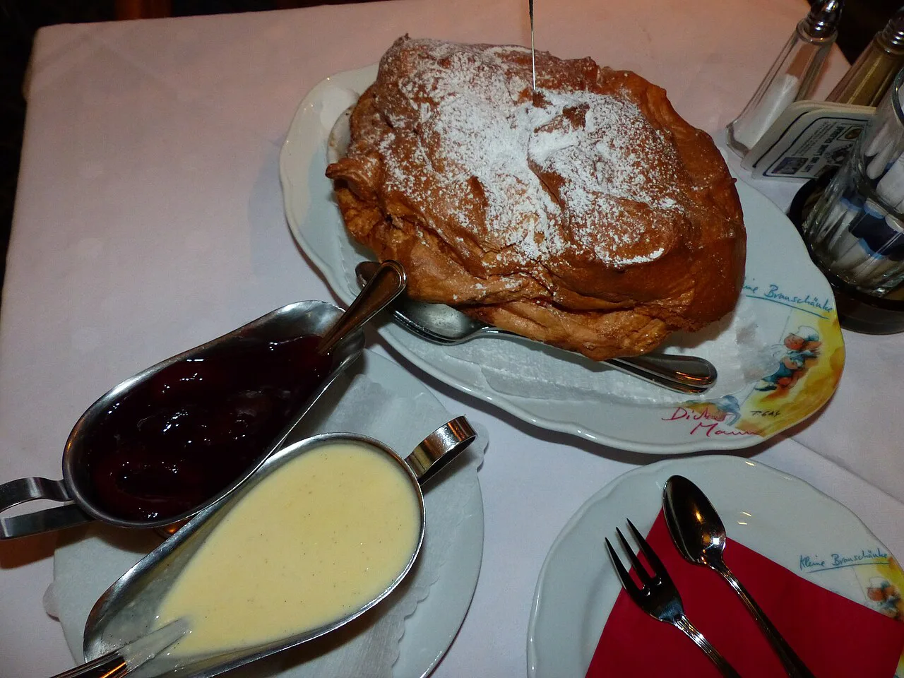 Salzburger Nockerl served with plums and vanilla sauce.