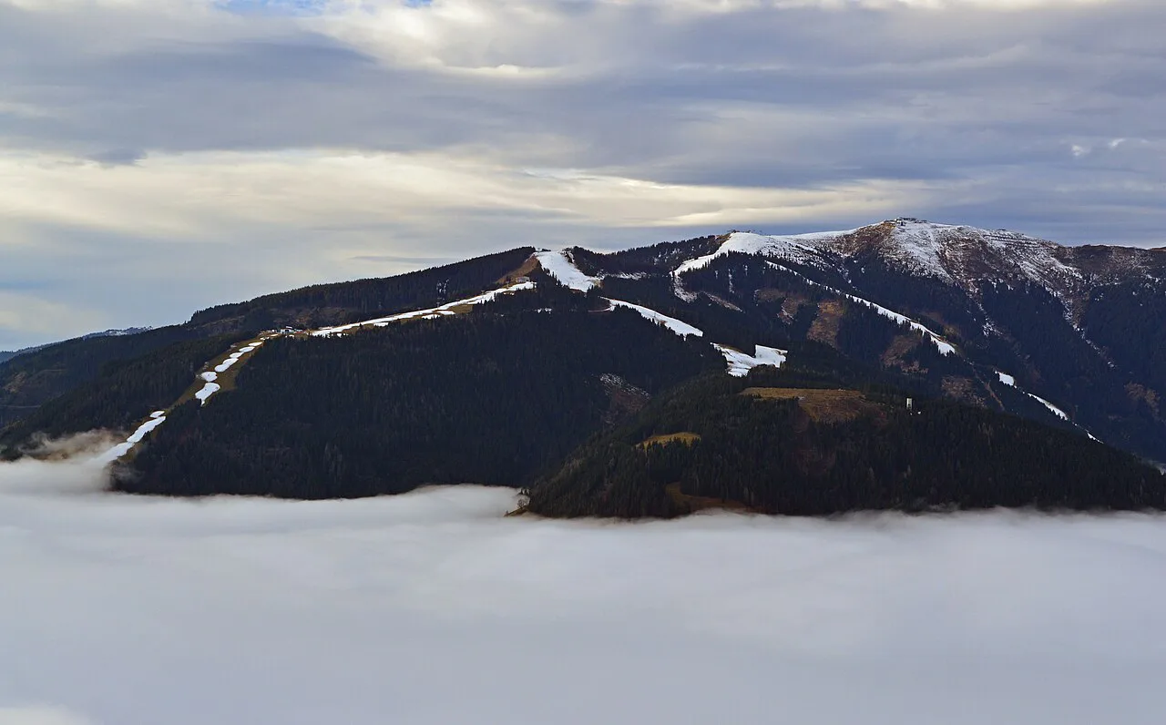 The Schmittenhöhe rising above fog that fills the Zell am See basin.