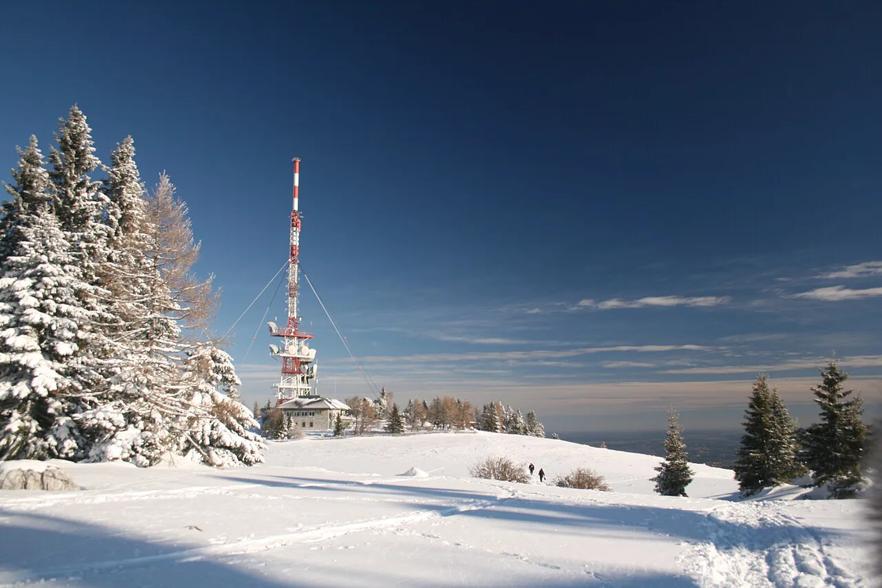 The snow-covered Schöckl summit with its transmitter mast in winter.