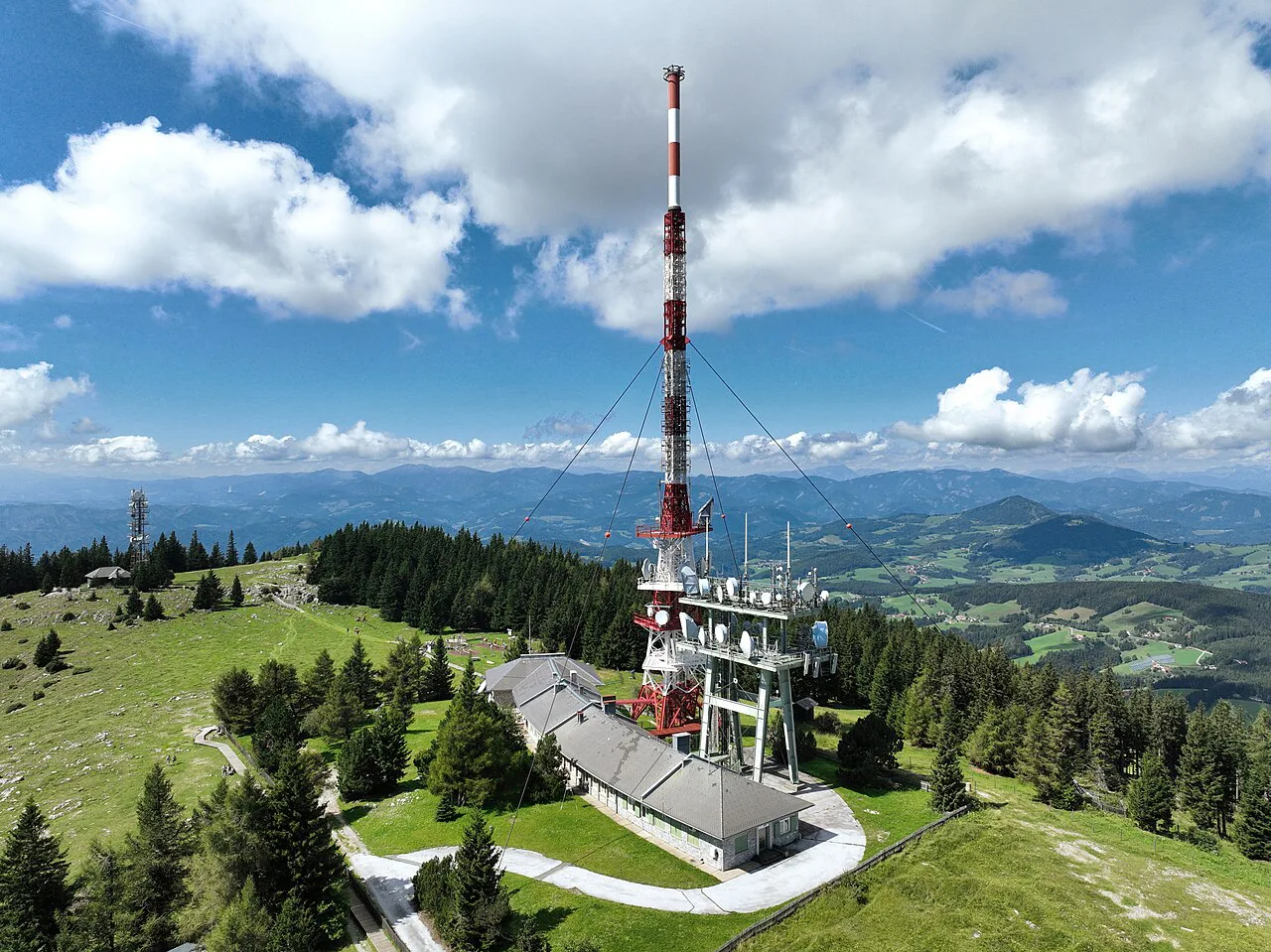 The Schöckl transmitter tower above the summit meadows.